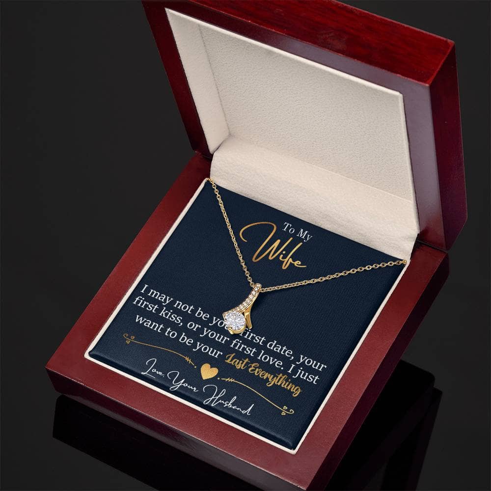 Alt text: "Personalized Wife Necklace: A ribbon-shaped pendant in a box, crafted in 14k white gold or 18k yellow gold over stainless steel, adorned with a 7mm cubic zirconia. Adjustable chain length. Secured with a lobster clasp."
