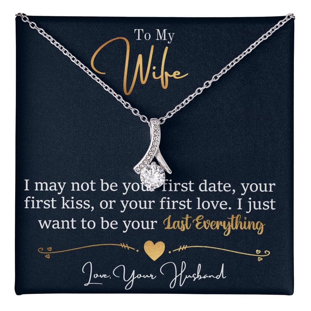 Alt text: "Personalized Wife Necklace: A sparkling ribbon-shaped pendant with a 7mm cubic zirconia on a black box, symbolizing endless love and connection."
