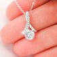 Alt text: "Personalized Wife Necklace: A hand holding a ribbon-shaped pendant with a sparkling cubic zirconia, symbolizing endless love and connection."