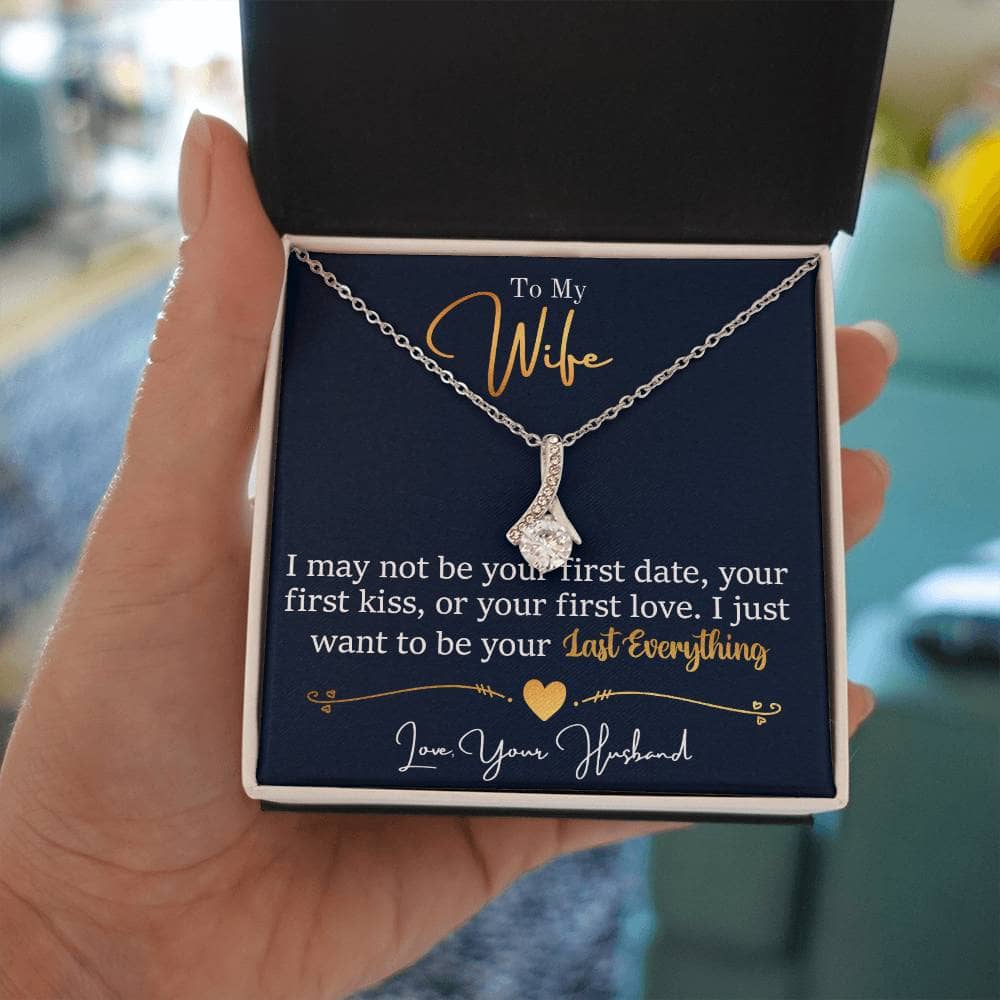 A hand holding the Personalized Wife Necklace: Symbol Of Love And Connection in a box.