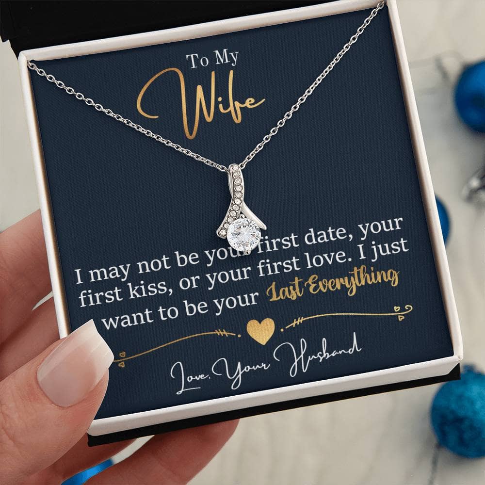 Alt text: "A hand holding the Personalized Wife Necklace: Symbol Of Love And Connection in a box"