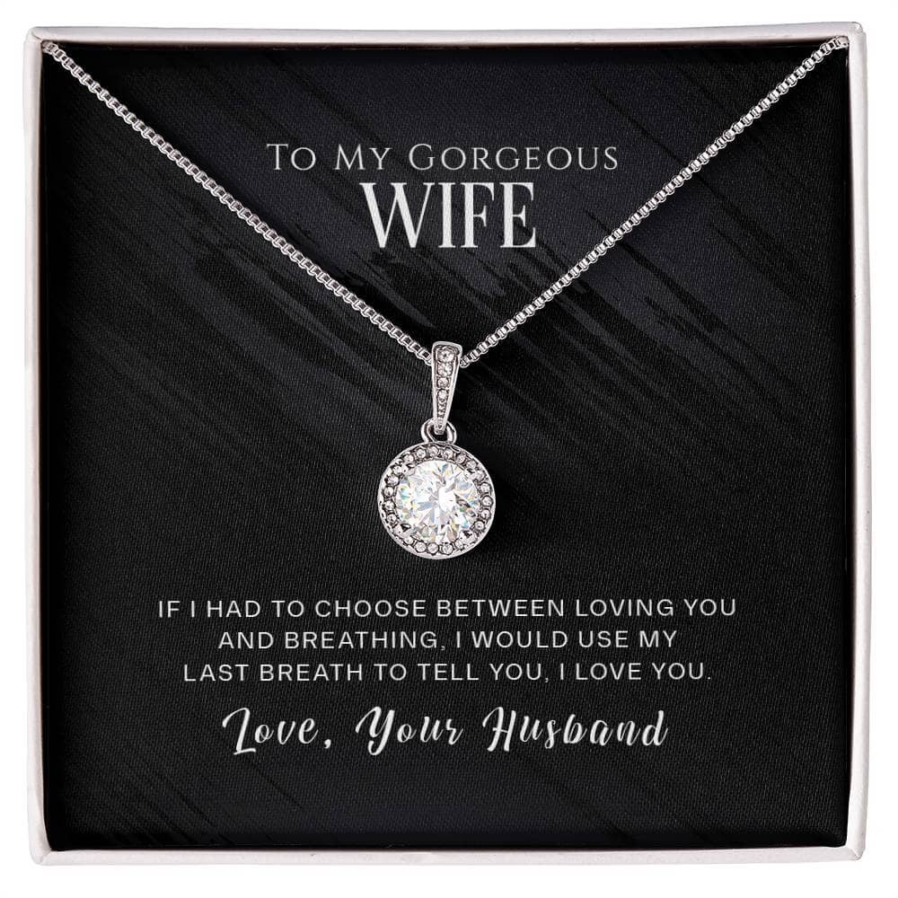Alt text: "Eternal Hope Necklace - A radiant white gold pendant with a cushion-cut cubic zirconia centerpiece, surrounded by sparkling crystals. Adjustable box chain length. Comes in an elegant gift box."