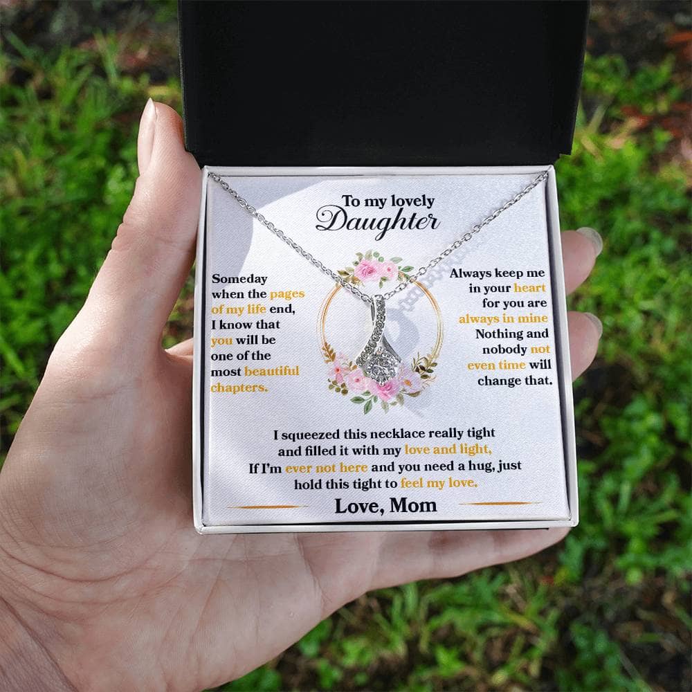Alt text: "Premium Personalized Daughter Necklace - a hand holding a necklace in a box, symbolizing an unyielding bond - a gift of love and connection."