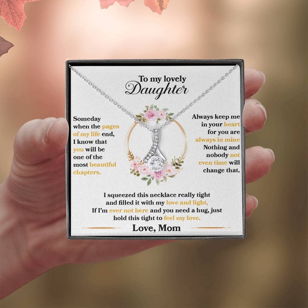Alt text: Premium Personalized Daughter Necklace - A hand holding a necklace with cubic zirconia pendant, symbolizing the unyielding bond between a parent and a daughter.