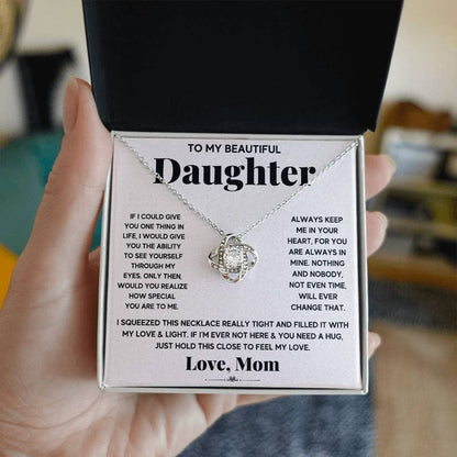 A hand holding a Premium Personalized Daughter Necklace with a heart pendant, symbolizing the timeless love between parents and daughters.