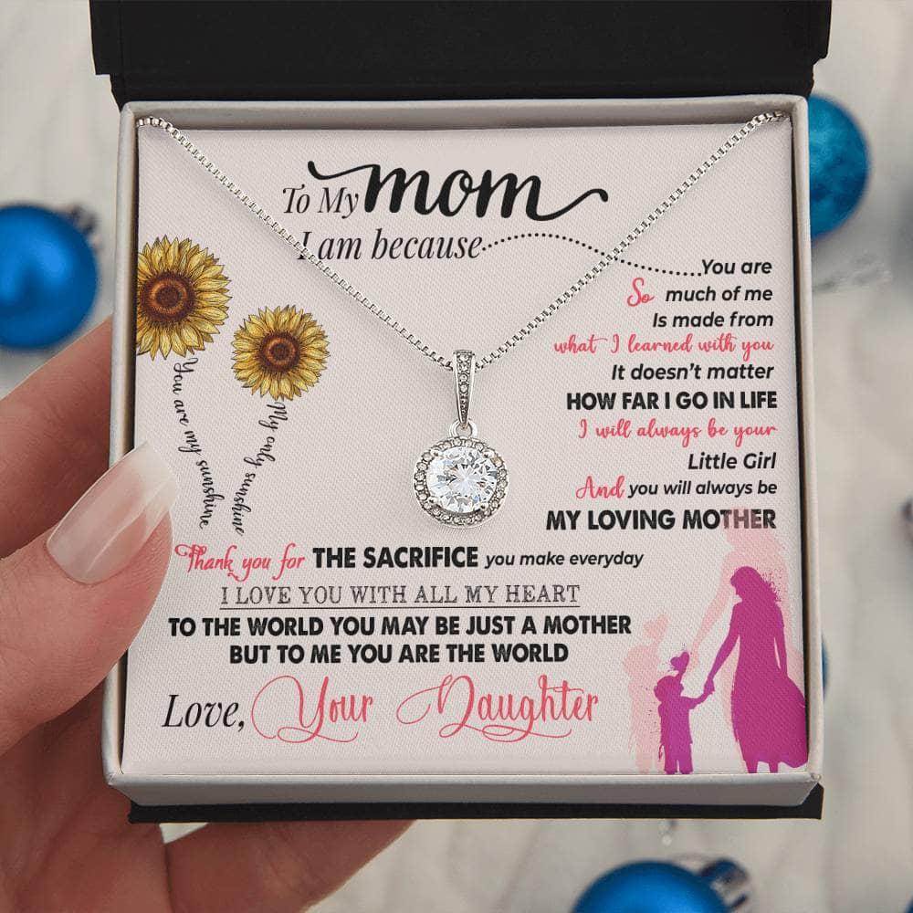 Alt text: "Hand holding premium Personalized Mother Necklace in a box, symbolizing unbreakable bond of love and care. Crafted with precision from cushion-cut cubic zirconia. LED-lit mahogany-style gift box for an unforgettable unboxing experience."