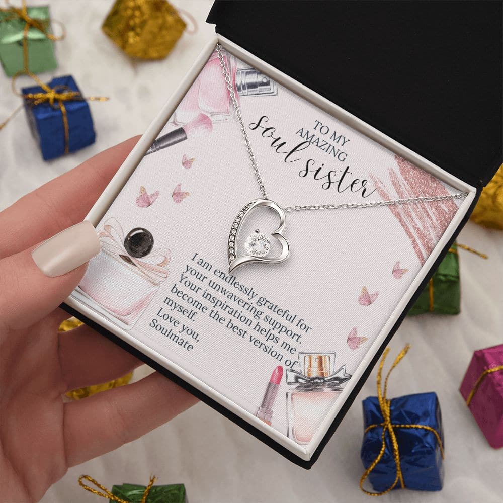 Alt text: "Hand holding Soulmate Unity Necklace in box, featuring heart pendant with CZ crystal. White or yellow gold finish. Personalized gift for everlasting love and elegance."