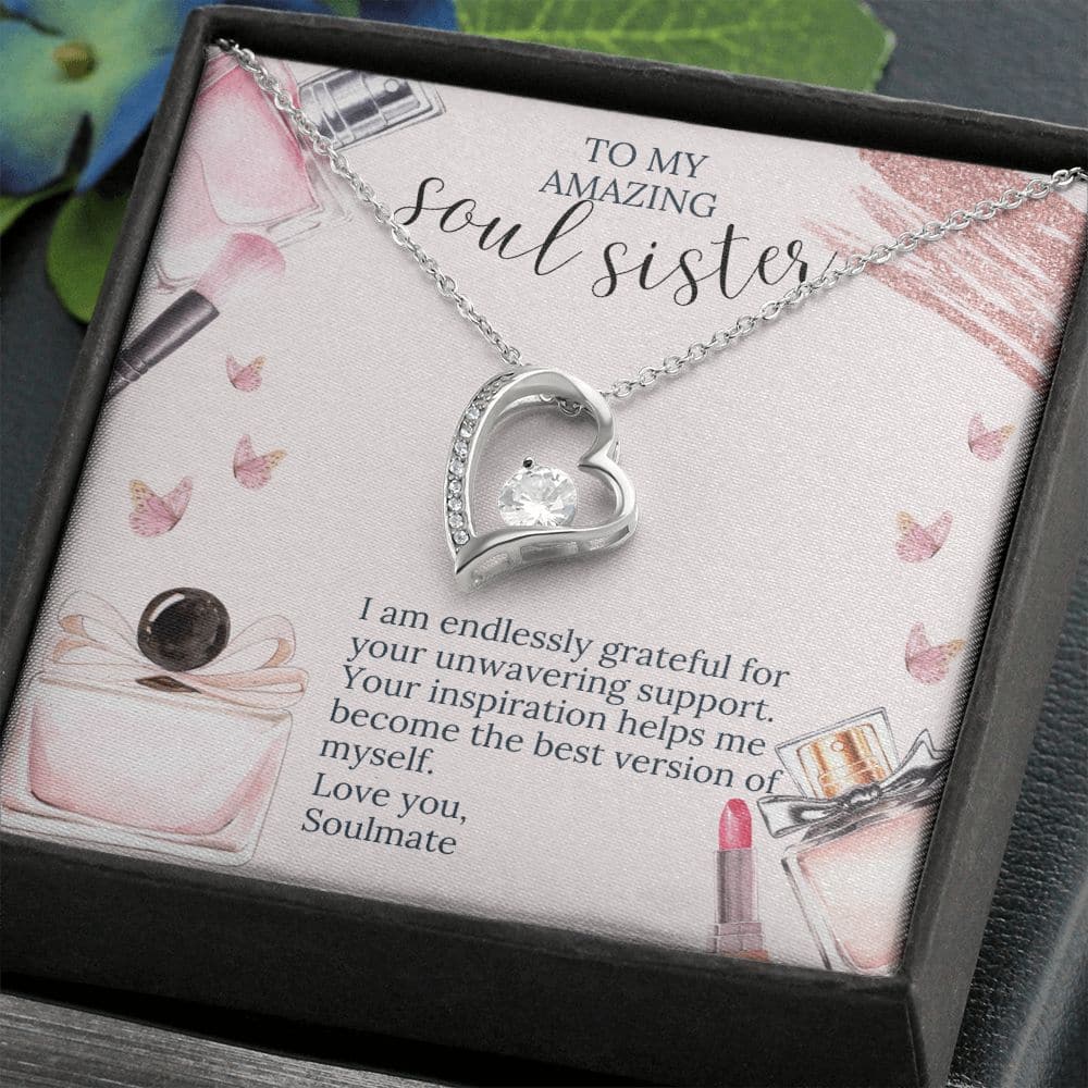 Alt text: "Soul Sister Unity Necklace Set - A necklace in a box with a heart pendant adorned with a 6.5mm CZ crystal, radiating love and sophistication. Choose from white gold or yellow gold finish. Pendant dimensions: 0.8" height / 0.7" width. Adjustable chain length: 18" - 22". Sturdy lobster clasp. Packaged in a soft touch box, ideal for gifting. Customizable pendant embodying eternal love. Explore our diverse necklace collections. Exclusive discount available."