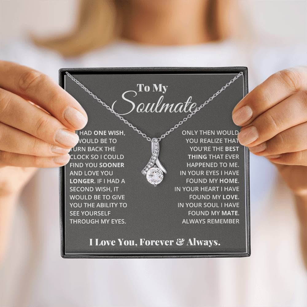 A person holding a personalized Soulmate Necklace, symbolizing love and commitment.