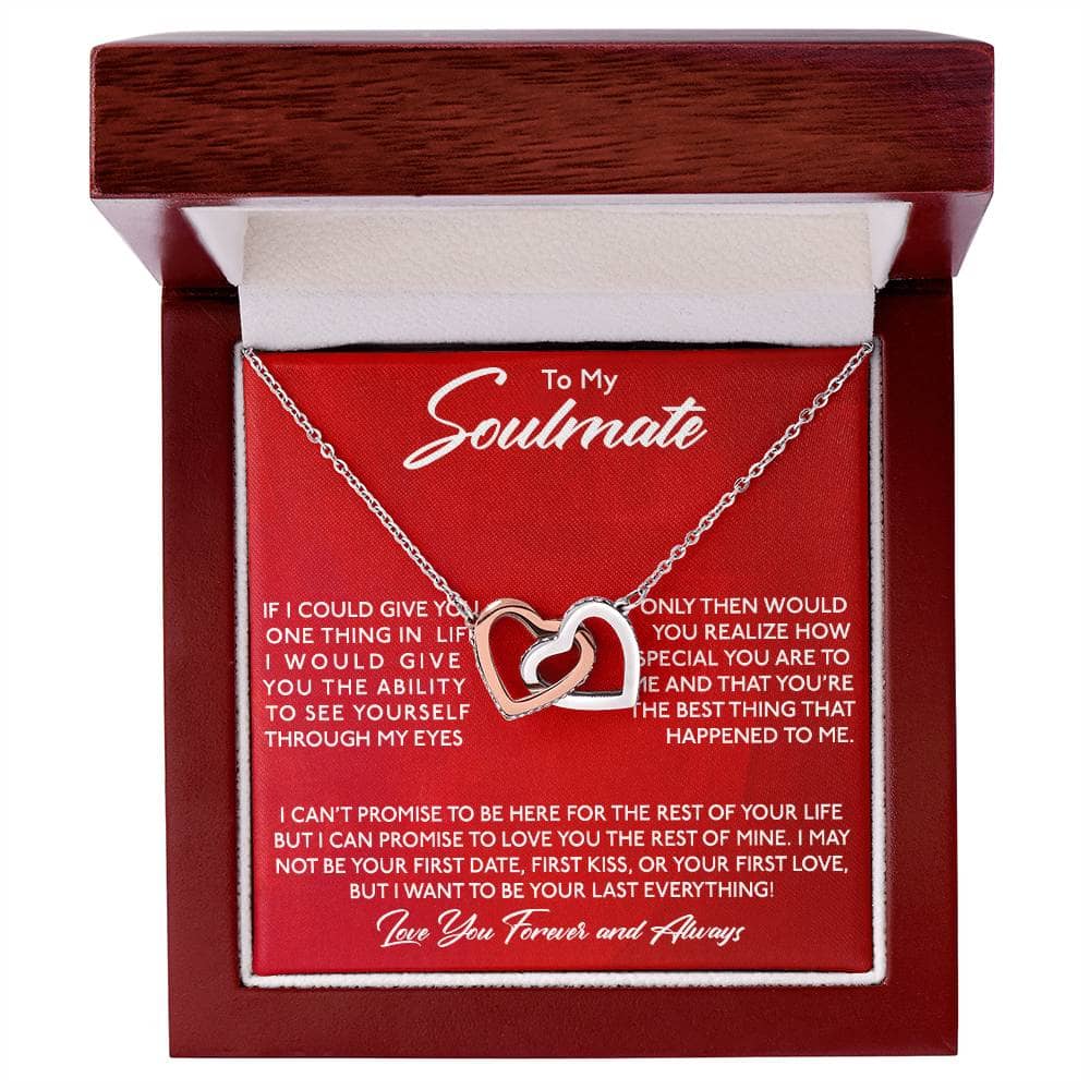 alt: "A personalized Soulmate Necklace with interlocking hearts, elegantly presented in a mahogany-style box with LED lighting"