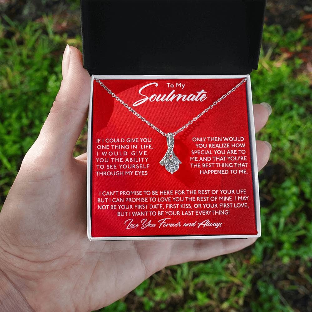 Alt text: "Hand holding Personalized Soulmate Necklace in mahogany-style box with LED lighting"