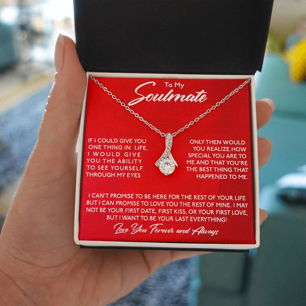 Alt text: "Hand holding Personalized Soulmate Necklace in a mahogany-style box with LED lighting"