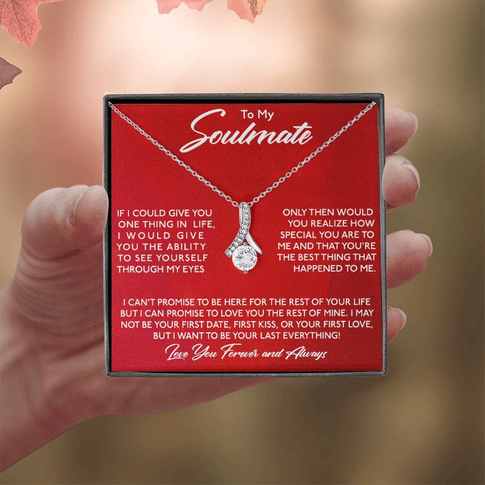Alt text: A hand holding a Personalized Soulmate Necklace in a box