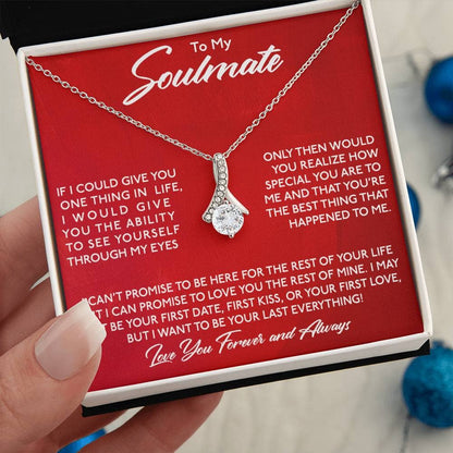 Alt text: A hand holding a Personalized Soulmate Necklace in a mahogany-style box with LED lighting