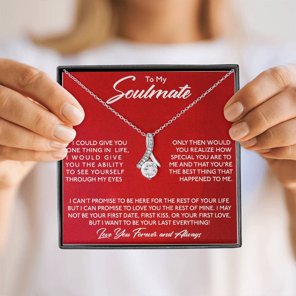 Alt text: "Person holding a Personalized Soulmate Necklace, featuring a silver chain and intricate pendant designs symbolizing soulmate connection and love."