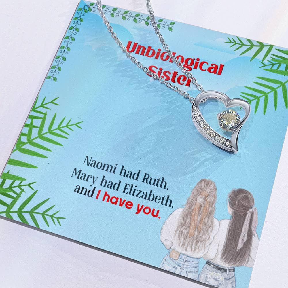 Alt text: "Personalized Unbiological Sisters Necklace on card, featuring interlocking hearts or love knots pendant with cubic zirconia. Symbol of sisterhood bond, available in 14k white gold or 18k gold finish. Daily wear-friendly adornment in mahogany-styled box."