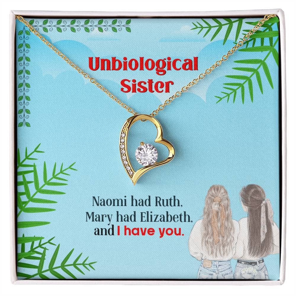 Alt text: "Unbiological Sisters Necklace in box, gold heart with diamond, symbolizing eternal bond and shared lives between sisters."
