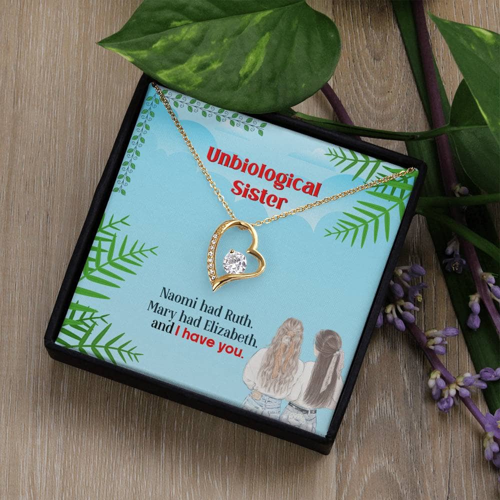 Alt text: "Unbiological Sisters Necklace in box with heart-shaped pendant and LED lighting"