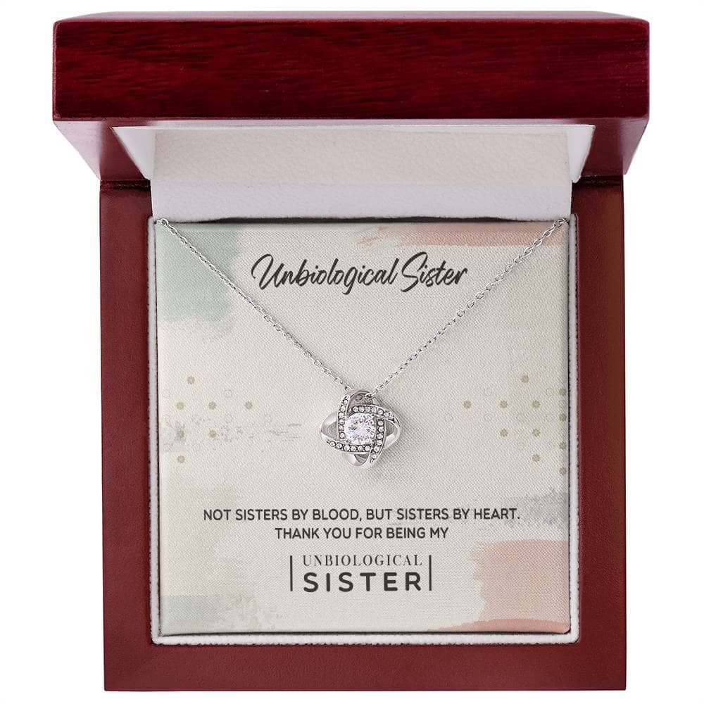 Alt text: "Unbiological Sister" Custom Love Knot Pendant in a box