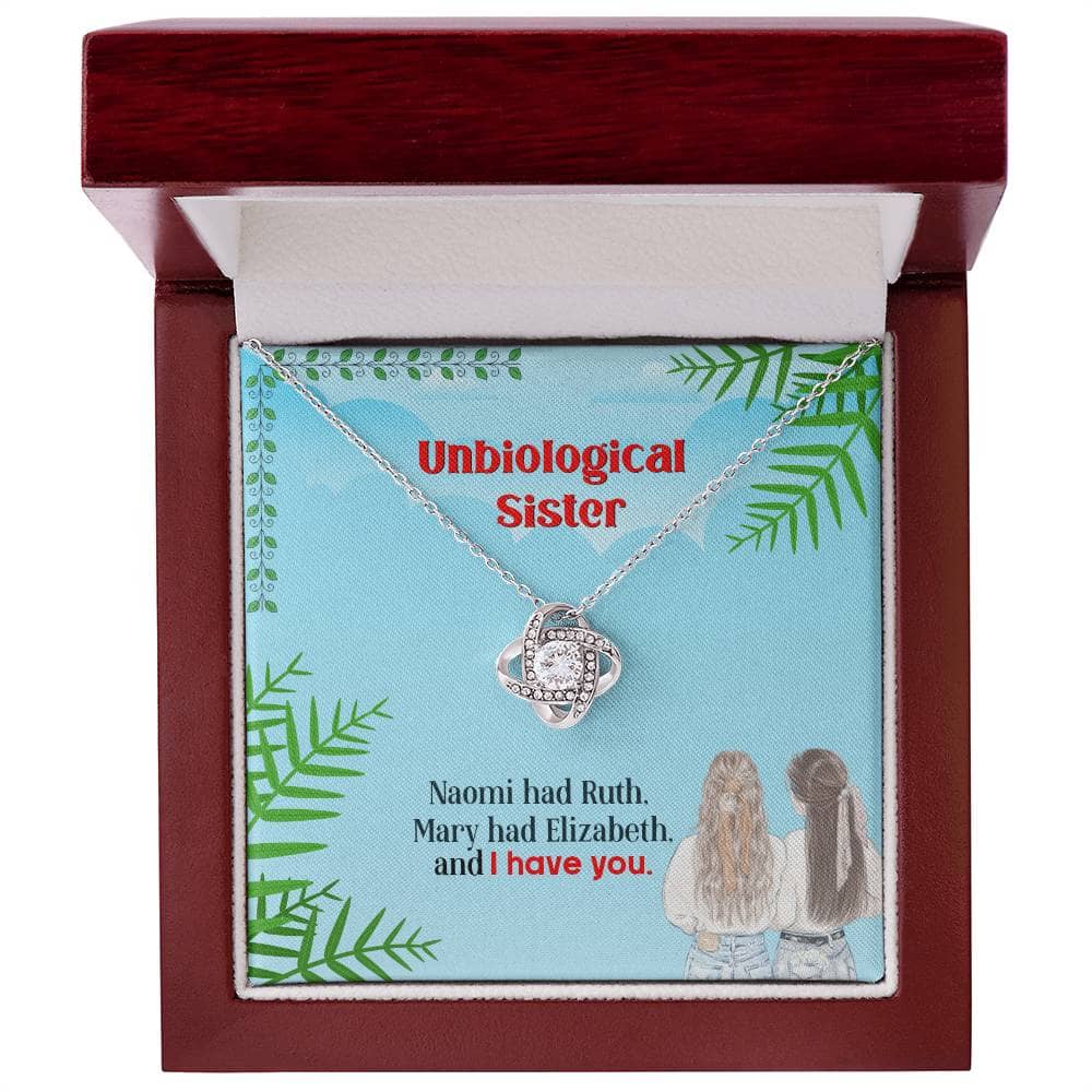 Alt text: "Unbiological Sister Personalized Love Knot Necklace in a chic mahogany-style box with LED lighting"