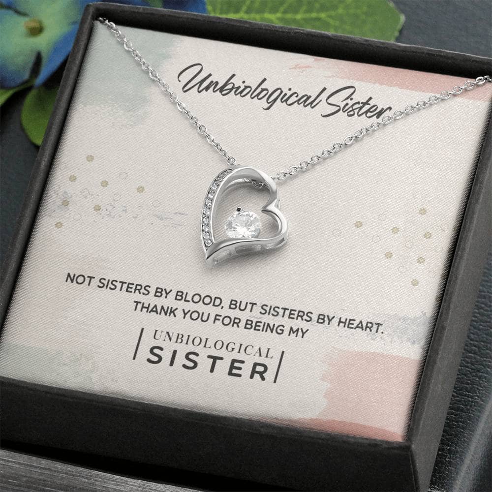 Alt text: "Personalized Unbiological Sisters Necklace in a mahogany-style box with LED lighting"