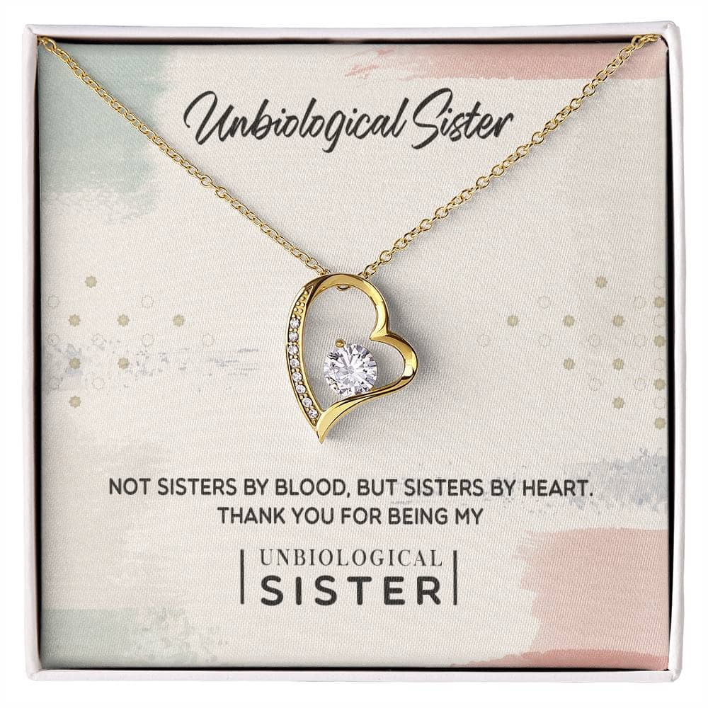 Alt text: "Personalized Unbiological Sisters Necklace in a box, featuring a gold heart with a diamond, symbolizing an unbreakable bond of sisterhood."