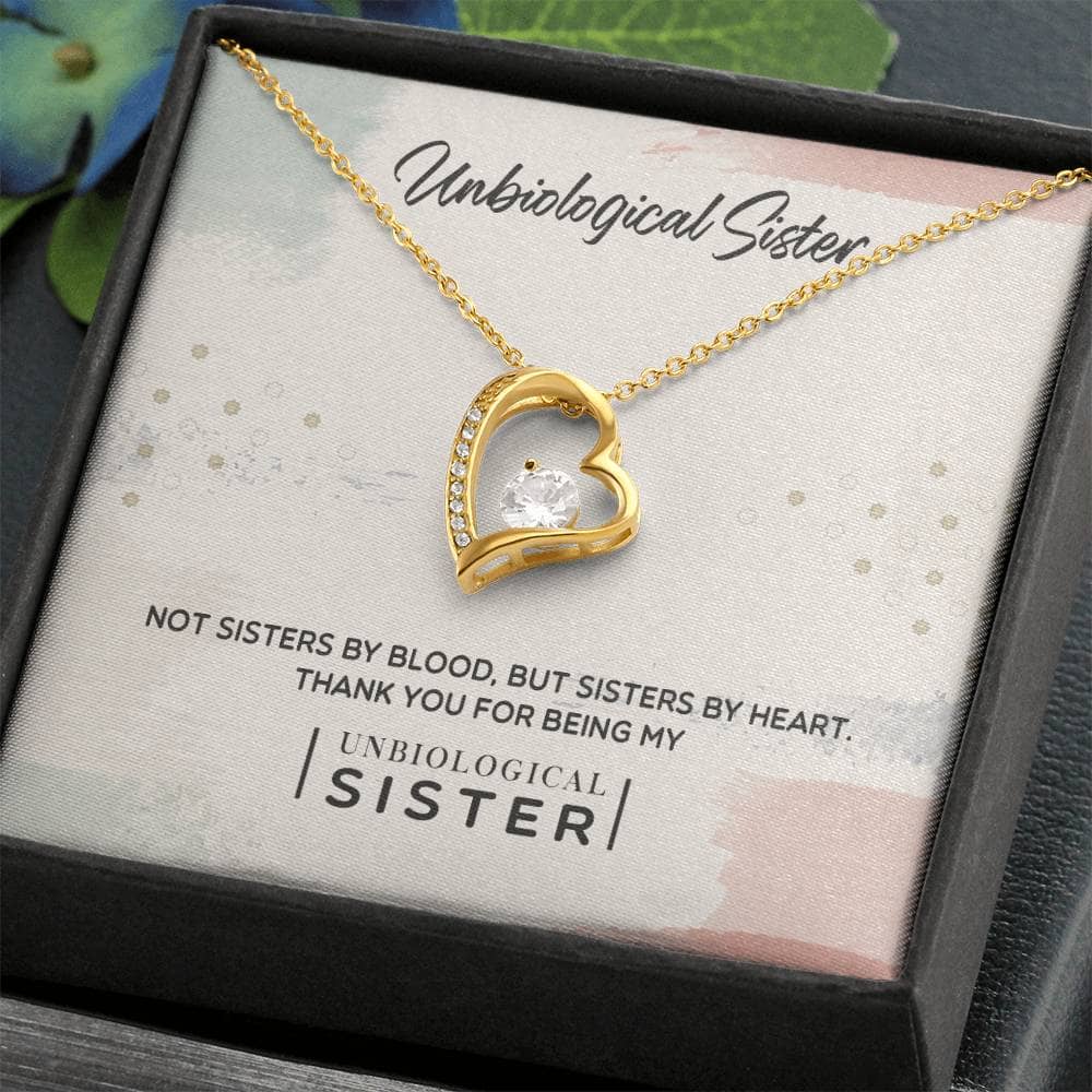 A gold heart necklace in a box, symbolizing the unbreakable bond of unbiological sisters. Crafted with care and adorned with cubic zirconia, this personalized necklace is a lasting tribute to sisterhood.